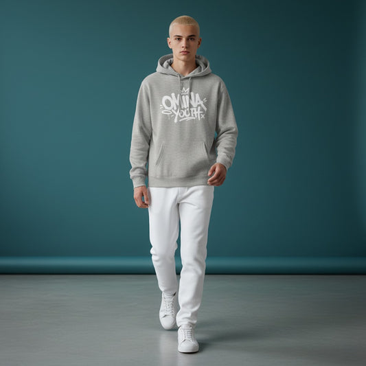Model wearing an Omina heather grey fleece hoodie with white graffiti-style chest graphic and white jeans.