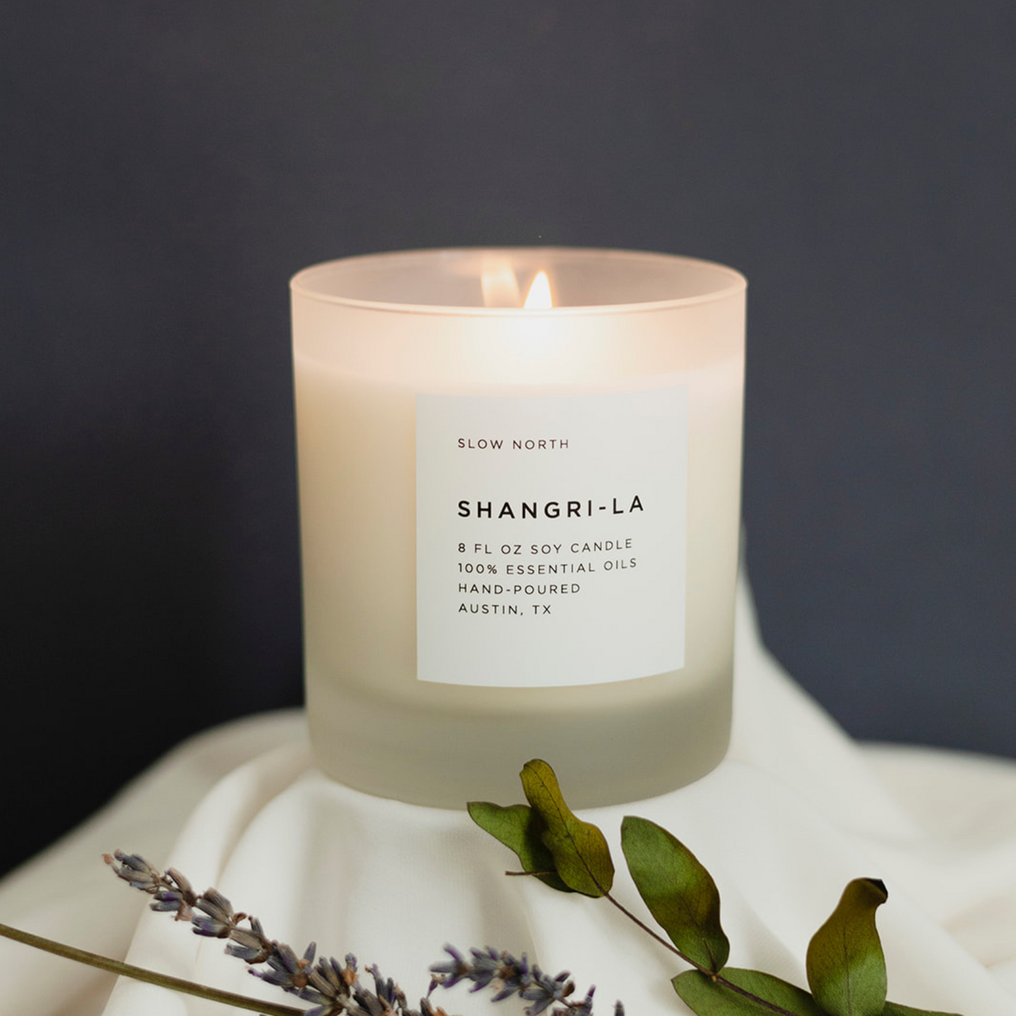 Frosted candle by Slow North, Shangri-La Signature Candle in 8oz with eucalyptus, lavender, and lemongrass scent, in a frosted glass jar.