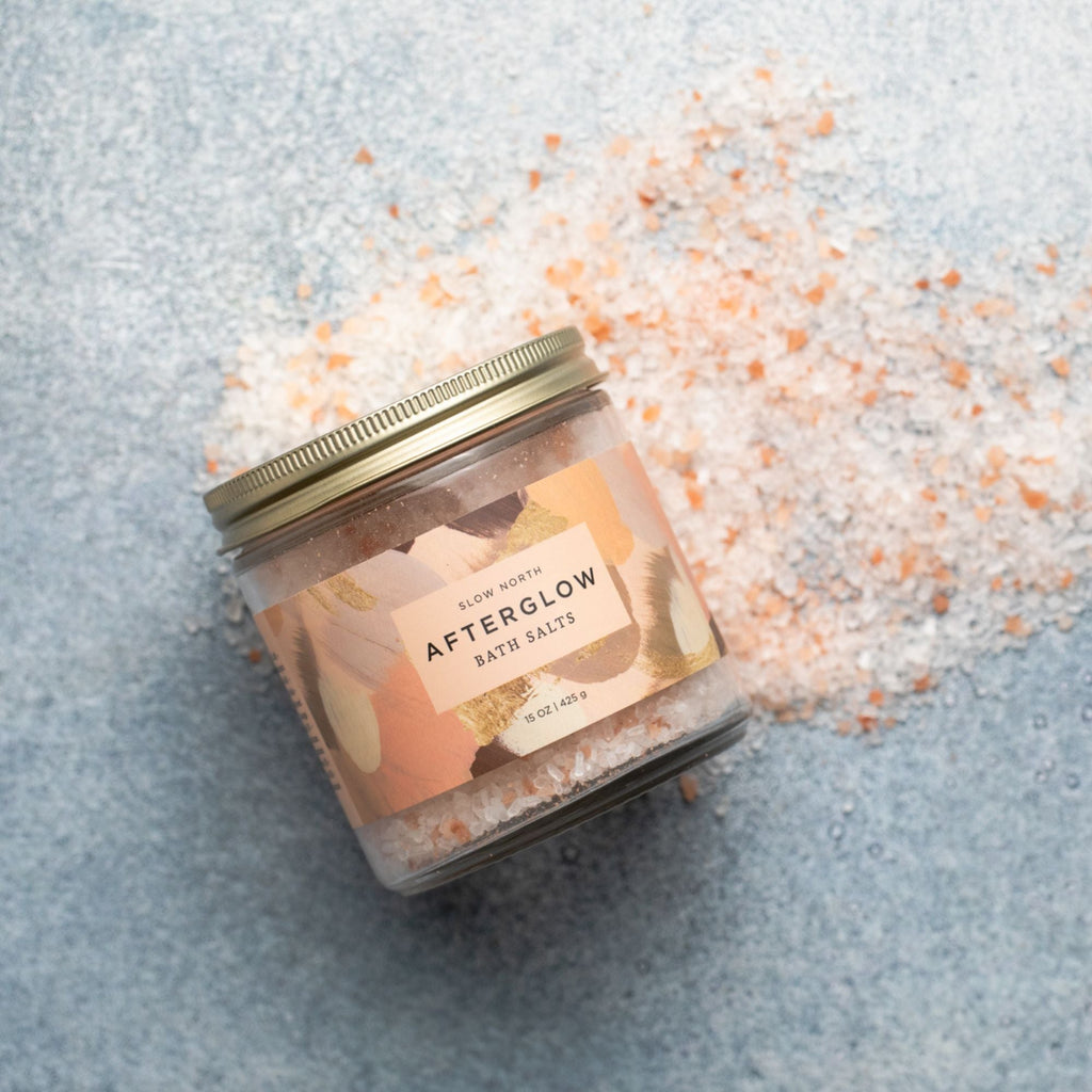Slow North Afterglow Bath Salts in 15 oz jar, relaxing body care product with pink and white salts in a clear glass jar.