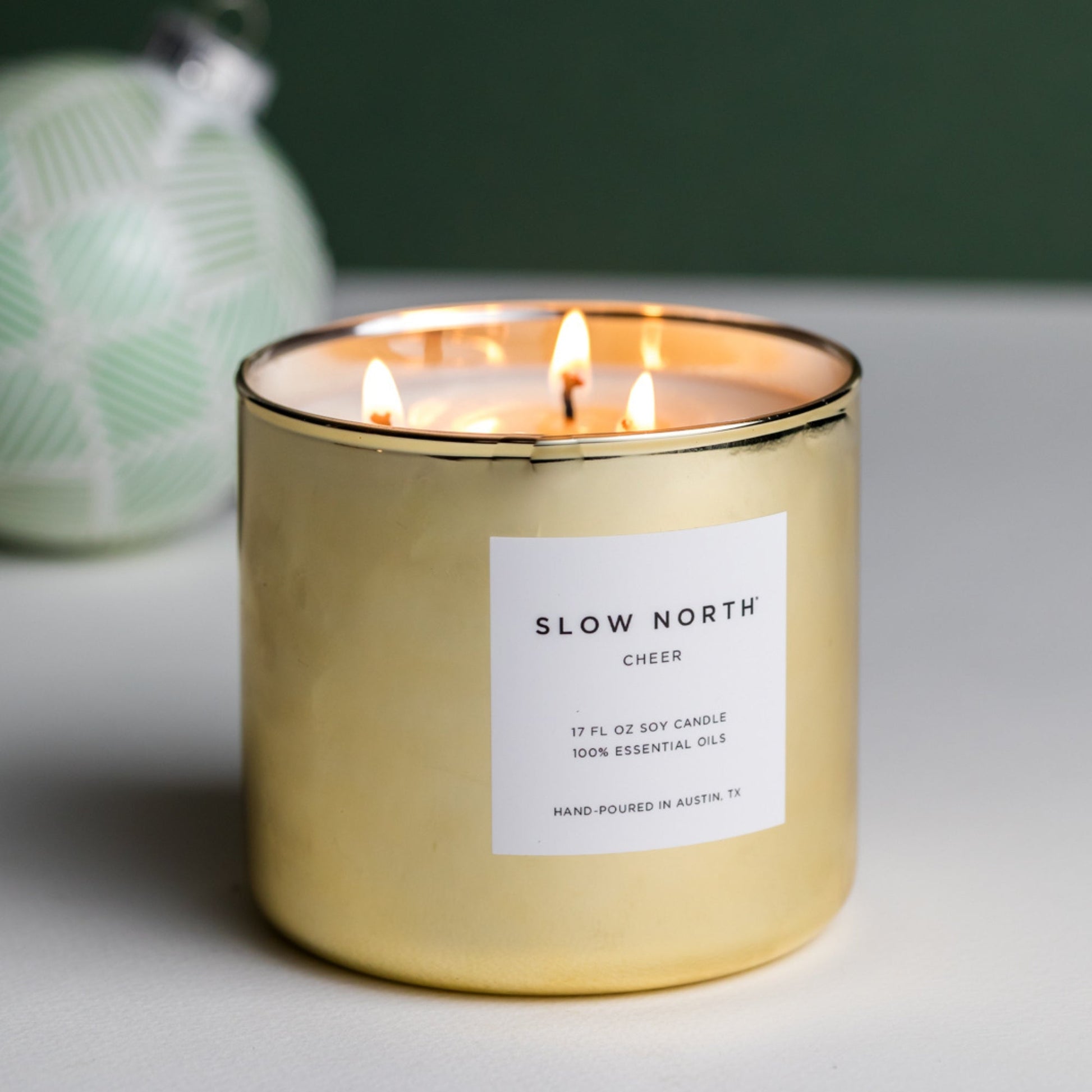 Slow North Cheer Signature 3-Wick Candle with seasonal festive design and three wicks for a warm, cozy ambiance.