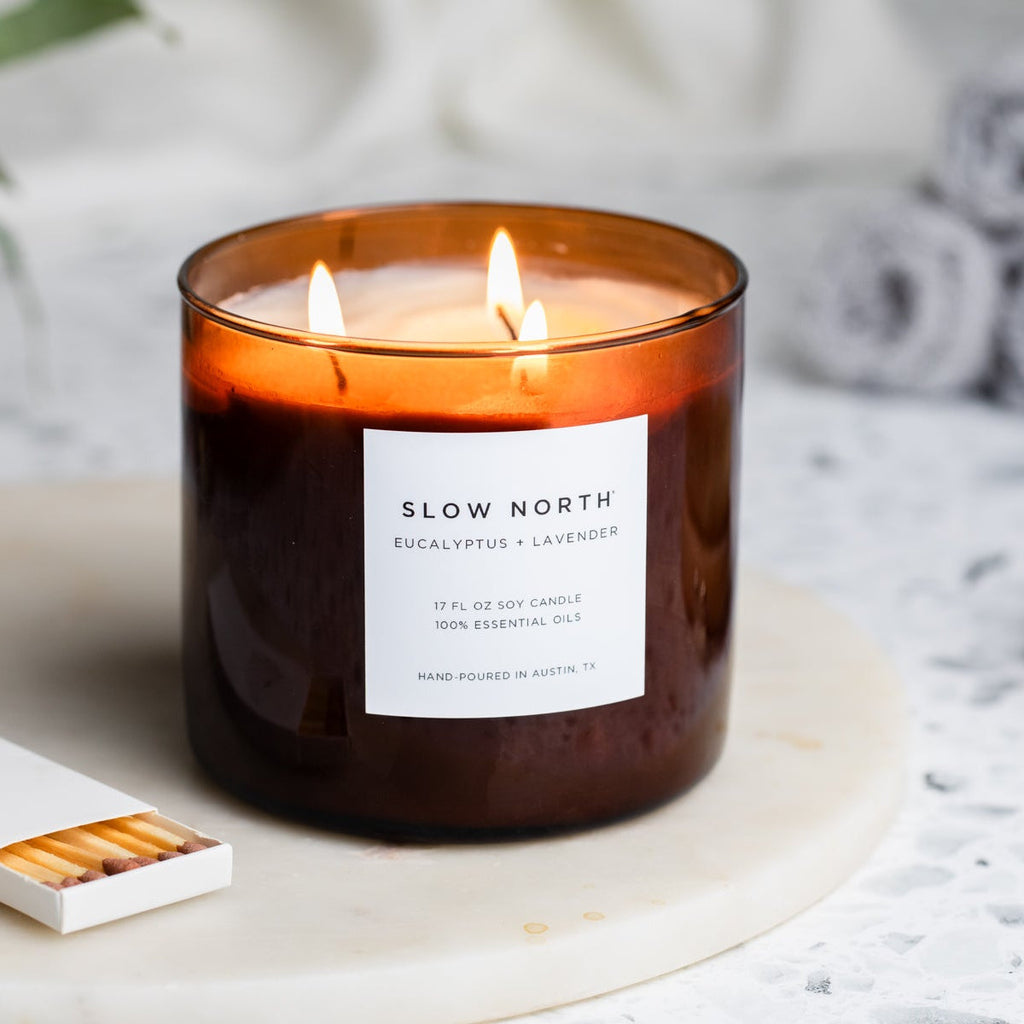 Slow North Signature 3-Wick Candle with eucalyptus and lavender in a glass jar, showcasing fresh botanical scents and a three-wick design.