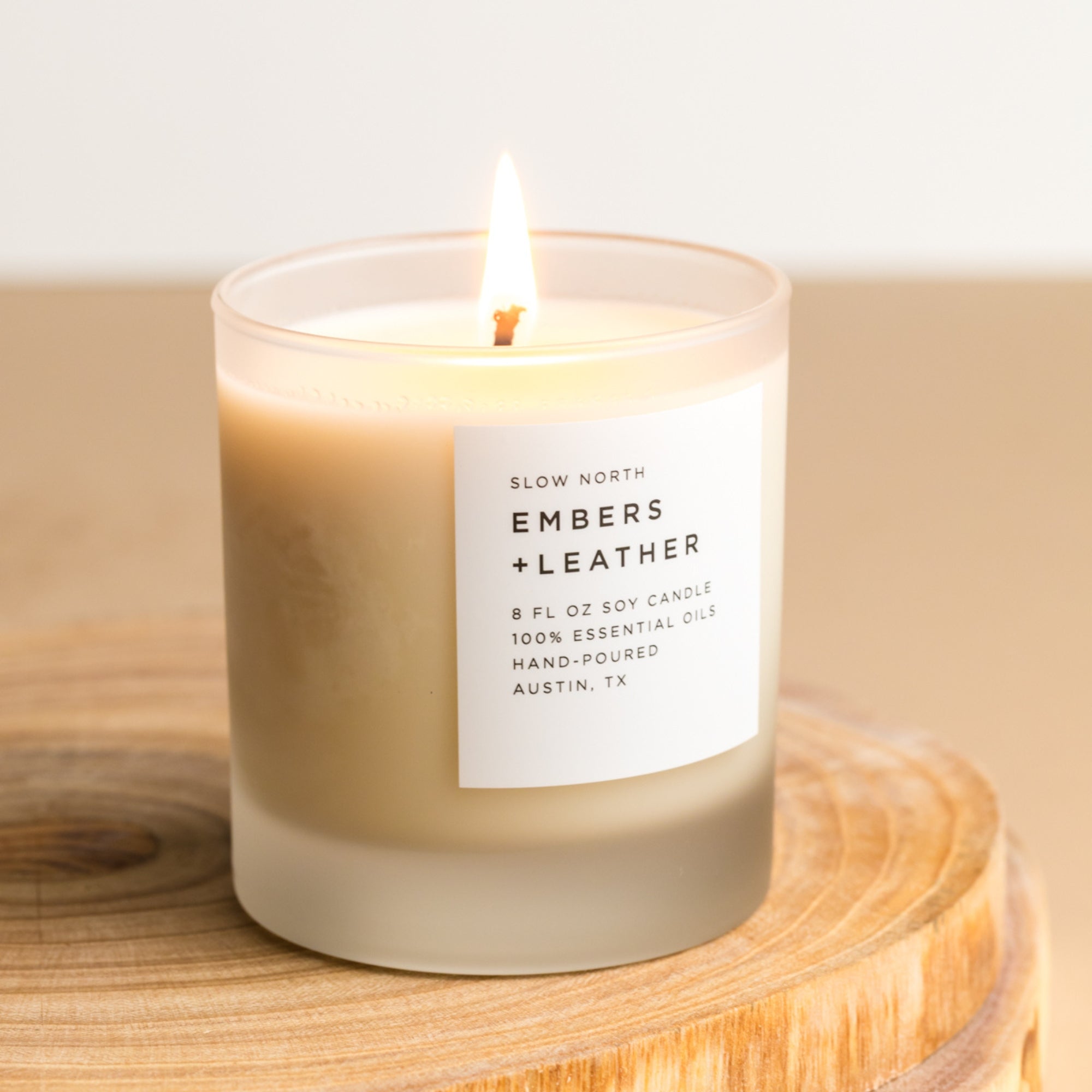 Frosted candle by Slow North featuring Embers + Leather signature scent with vetiver, cedar, and patchouli notes.