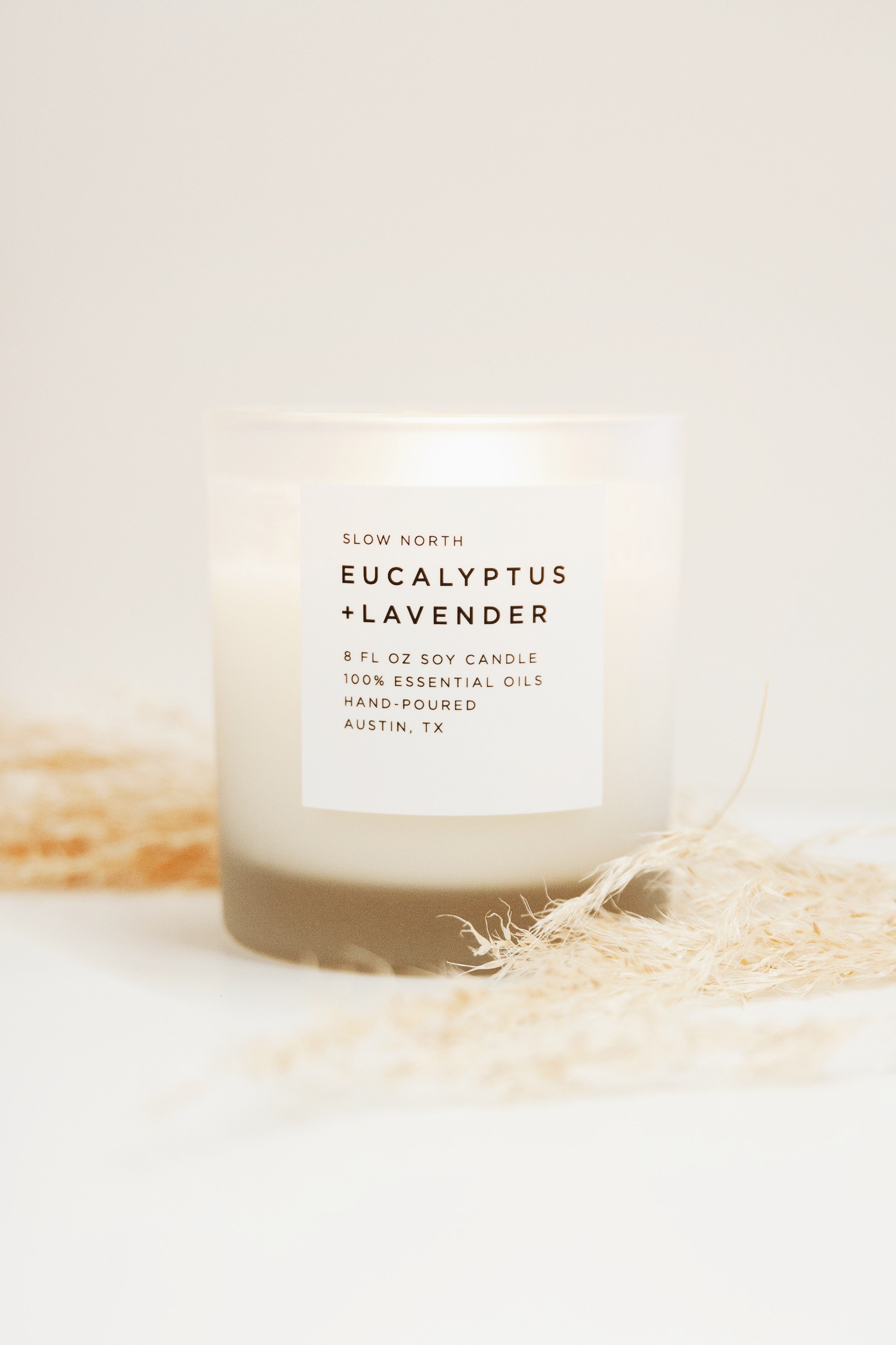 Frosted soy candle with eucalyptus and lavender scent by Slow North, 8oz size, featuring a frosted glass container.