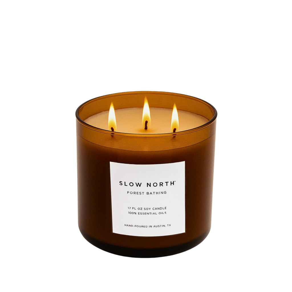Slow North Forest Bathing Signature 3-Wick Candle with lush green forest imagery and natural wooden accents.