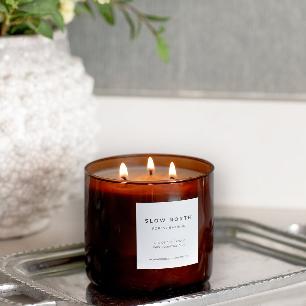 Slow North Forest Bathing Signature 3-Wick Candle with a glass jar, green foliage design, and three cotton wicks for a cozy ambiance.
