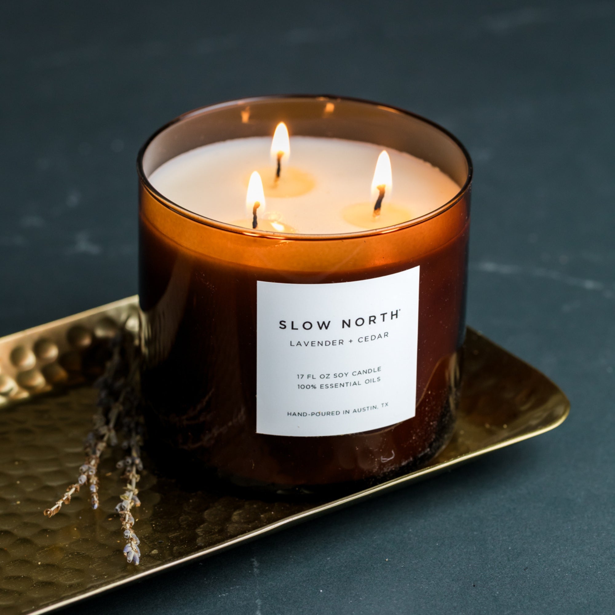 Slow North Lavender + Cedar Signature 3-Wick Candle with lavender and cedarwood in a glass jar, ready to create a calming ambiance.