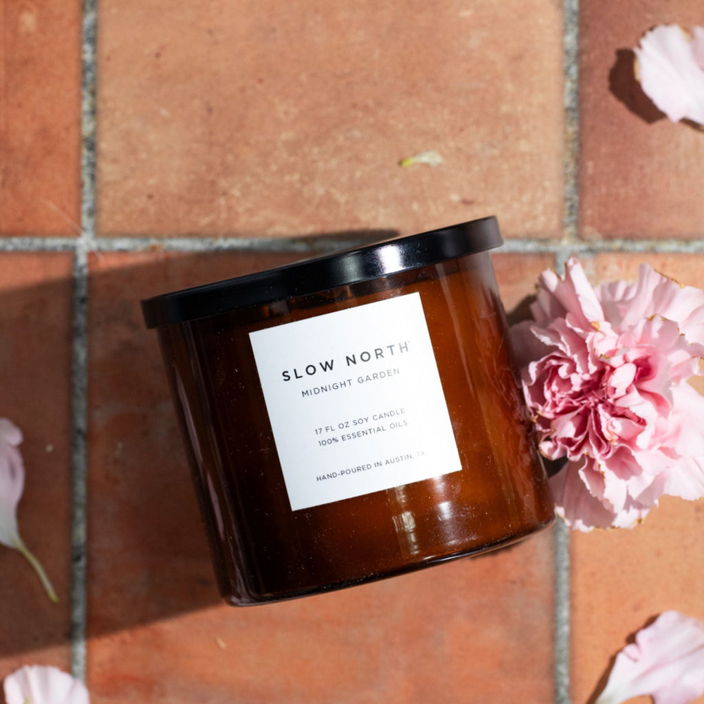 Slow North Midnight Garden Signature 3-Wick Candle with lavender, rosemary, and geranium in a sleek glass jar.
