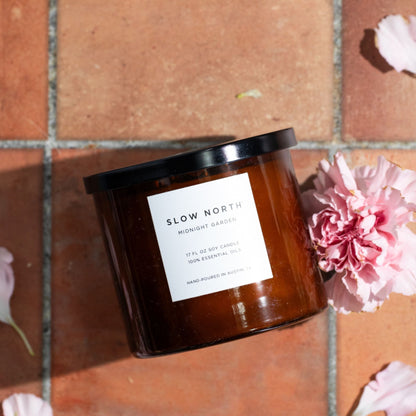 Slow North Midnight Garden Signature 3-Wick Candle with lavender, rosemary, and geranium in a sleek glass jar.
