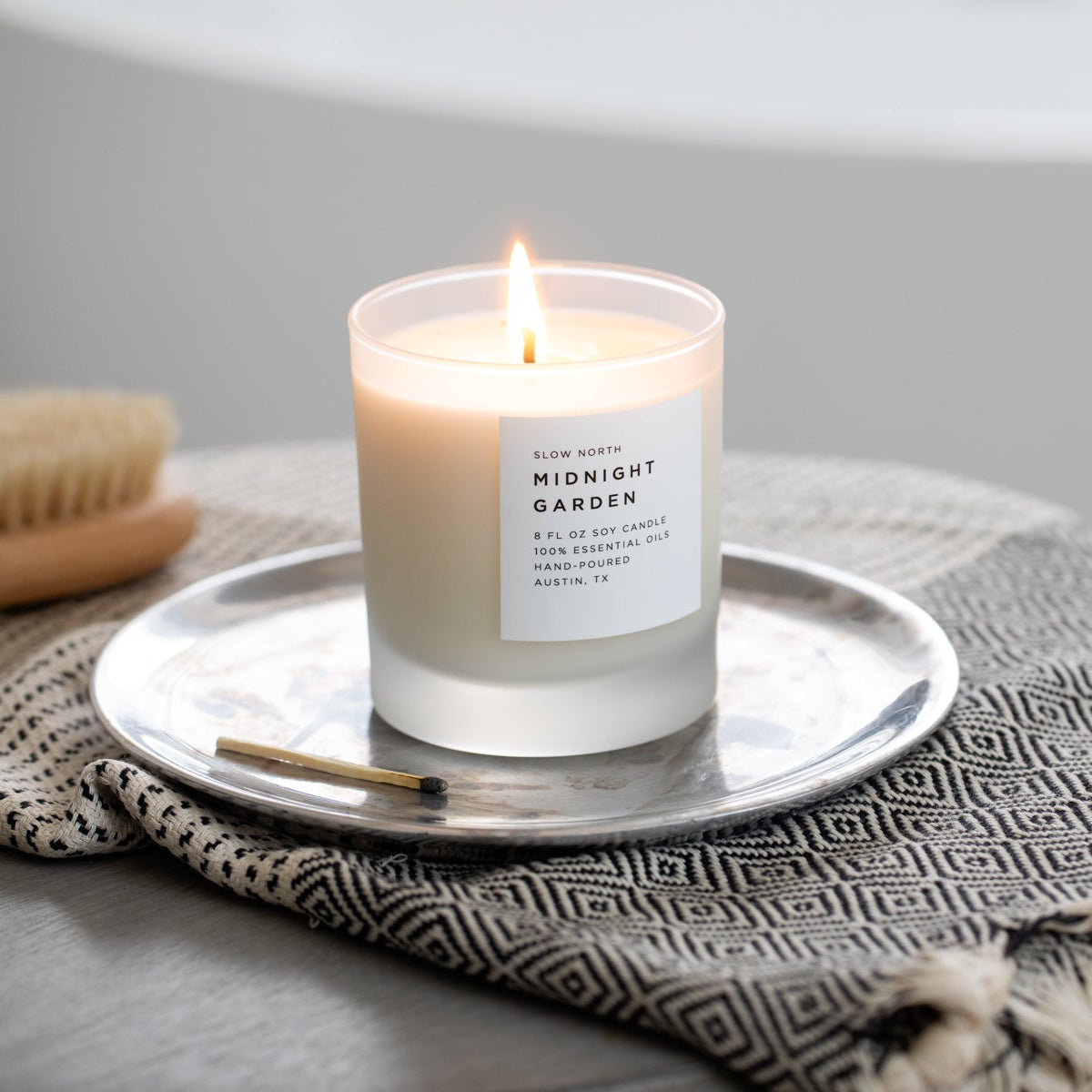 Frosted candle from Slow North’s Midnight Garden collection with lavender, rosemary, and geranium scent.