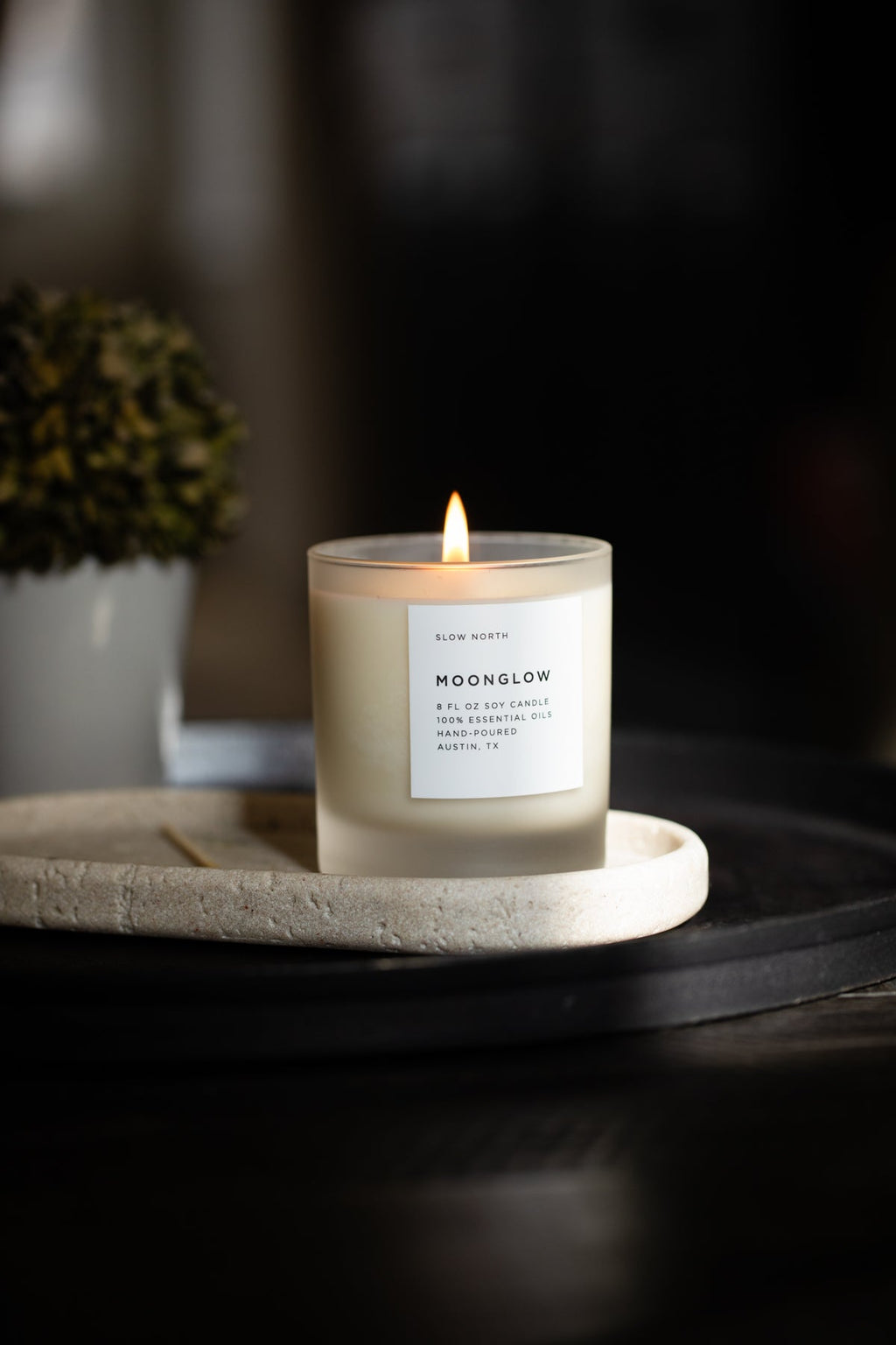 Frosted candle from Slow North’s Moonglow Signature Candle line with patchouli, cinnamon, and black pepper scent.