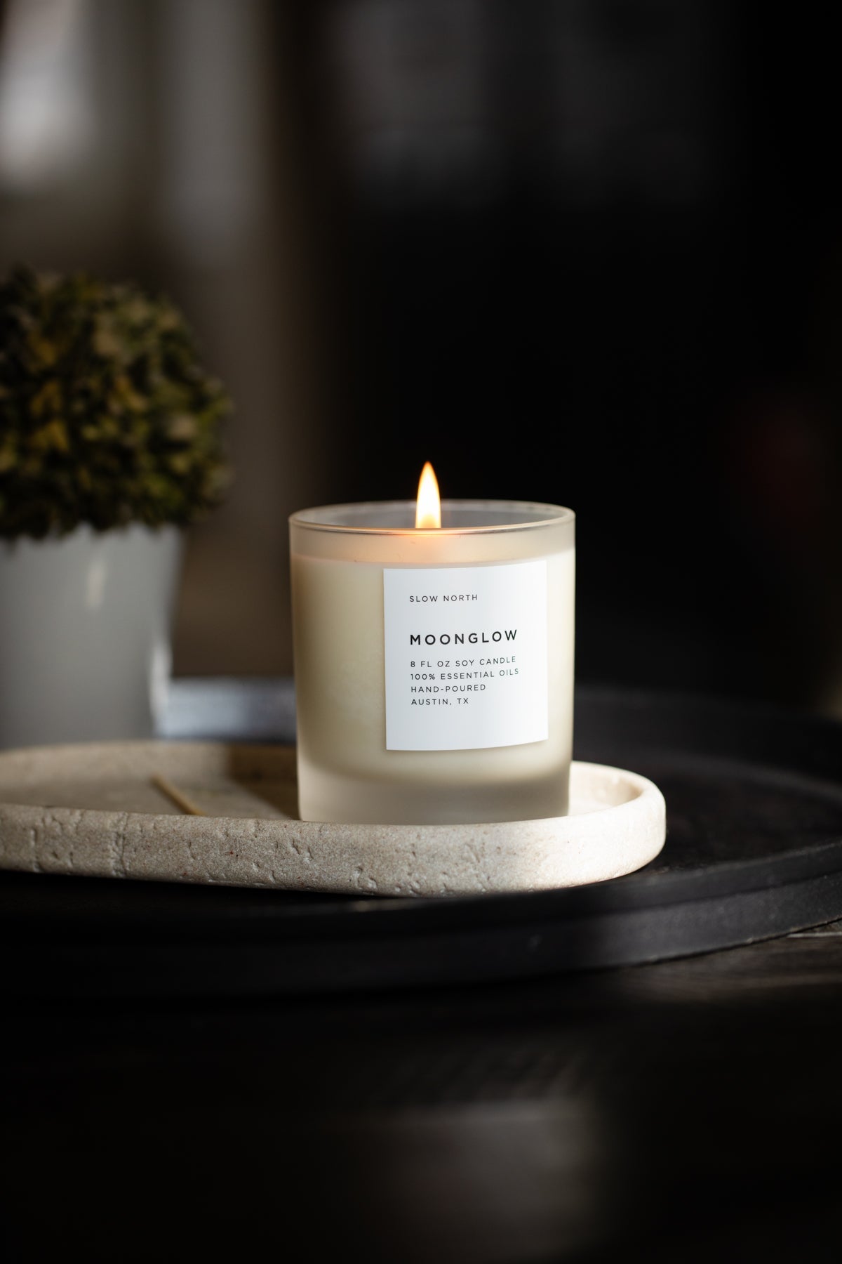 Frosted candle from Slow North’s Moonglow Signature Candle line with patchouli, cinnamon, and black pepper scent.