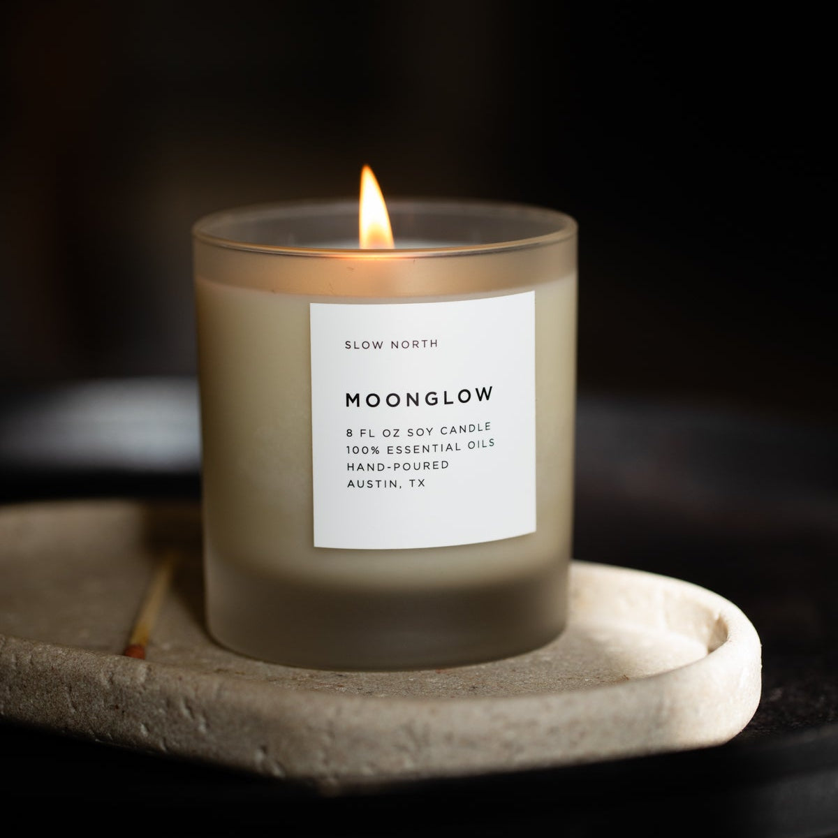 Frosted candle from Slow North's Moonglow Signature collection with patchouli, cinnamon, and black pepper scent.
