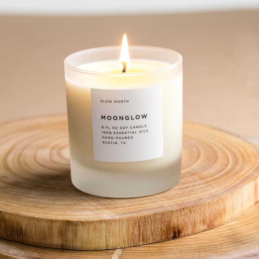 Frosted candle from Slow North's Moonglow Signature collection with patchouli, cinnamon, and black pepper scent.