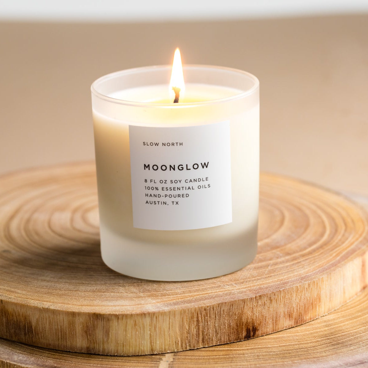 Frosted candle from Slow North's Moonglow Signature collection with patchouli, cinnamon, and black pepper scent.
