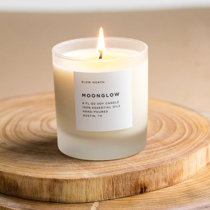 Frosted candle from Slow North's Moonglow Signature collection with patchouli, cinnamon, and black pepper scent.