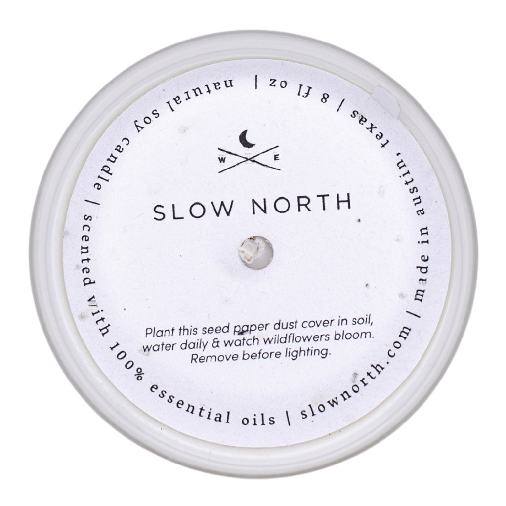 Frosted candle from Slow North featuring lemongrass and tangerine scent, with a dust cover and elegant design.