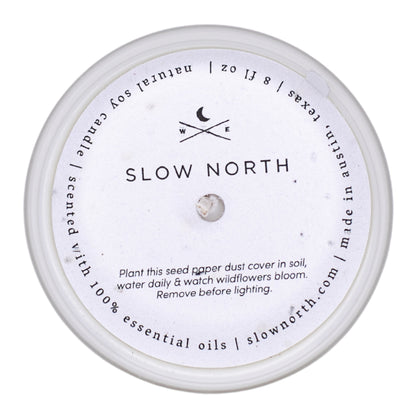 Frosted candle from Slow North with forest-inspired scent of fir, pine, and patchouli, featuring a dust-covered frosted glass container.
