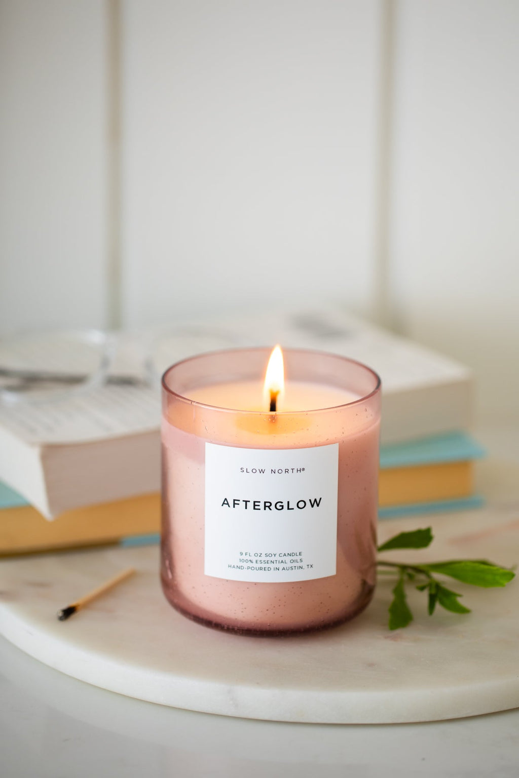 Slow North Afterglow Spa Collection candle with a minimalist glass holder and soft, warm glow for relaxing spa ambiance.