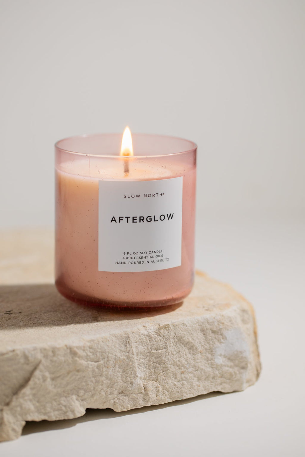 Slow North Afterglow spa candle with a sleek glass container, emitting a warm, relaxing glow perfect for calming spa environments.