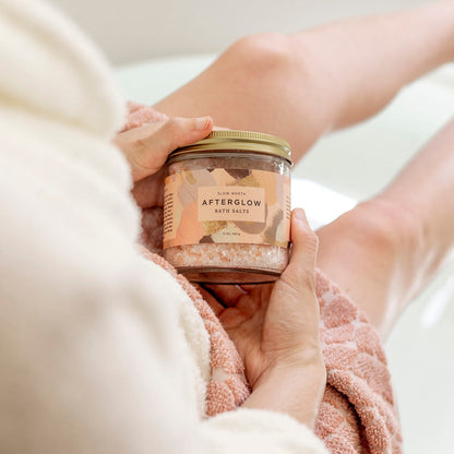 Slow North Afterglow Bath Salts in 15 oz jar, showing a clear glass container filled with pink and white bath salts for relaxing body care.