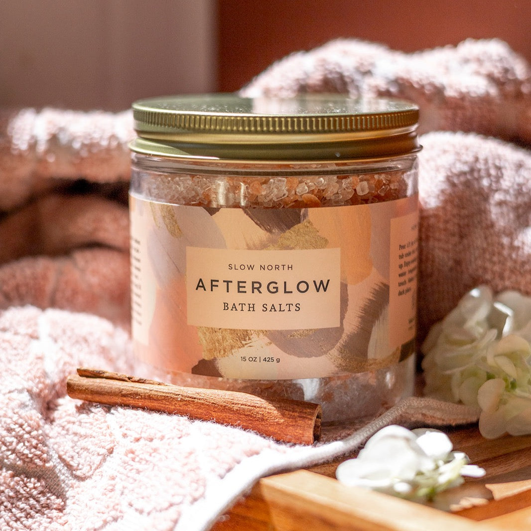 Slow North Afterglow Bath Salts in a 15 oz jar, showcasing a natural body care product with pink and white bath salts.