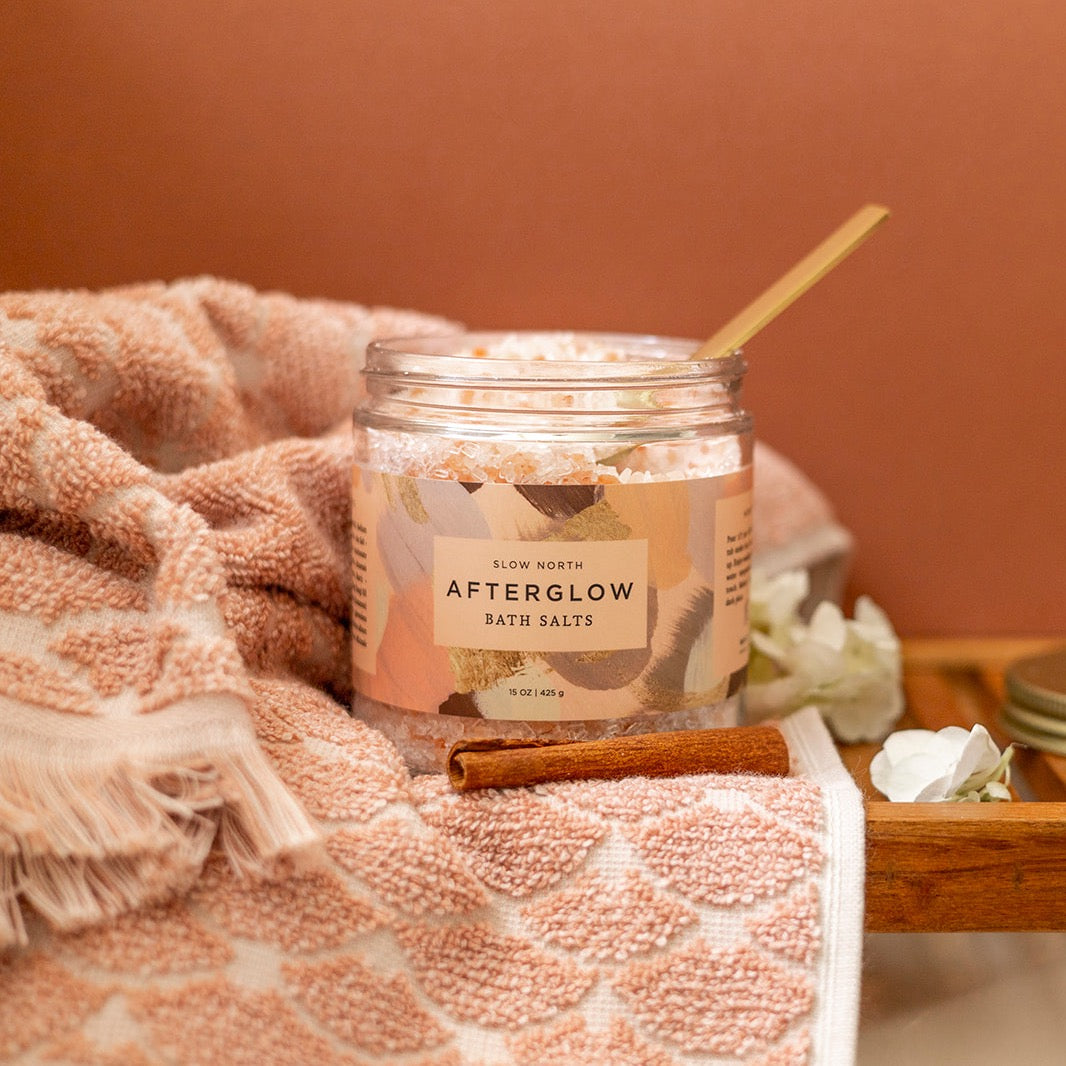 Slow North Afterglow Bath Salts in a 15 oz jar, showing the label and clear glass jar with pink bath salts inside.