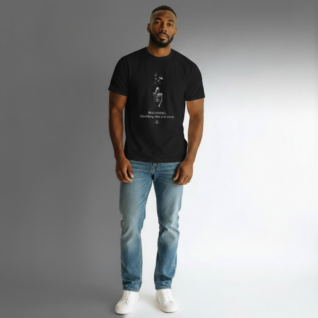 Model wearing a black Omina cotton graphic t-shirt with a stardust figure print and Becoming inspirational text.