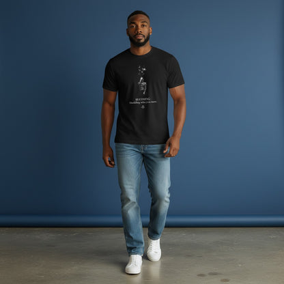 Model wearing a black Omina cotton graphic t-shirt with a stardust figure print and Becoming inspirational text.