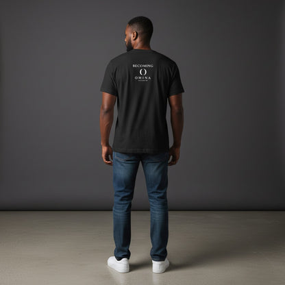 Man wearing a black Omina cotton t-shirt with a white Becoming logo on the back, paired with blue jeans.