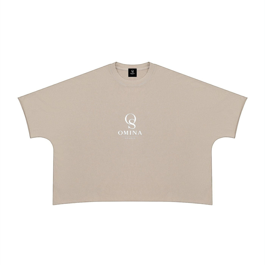 Omina beige 100% cotton unisex heavyweight boxy t-shirt with raw edge hem and crew neck, featuring a white Omina Studio logo on the chest.