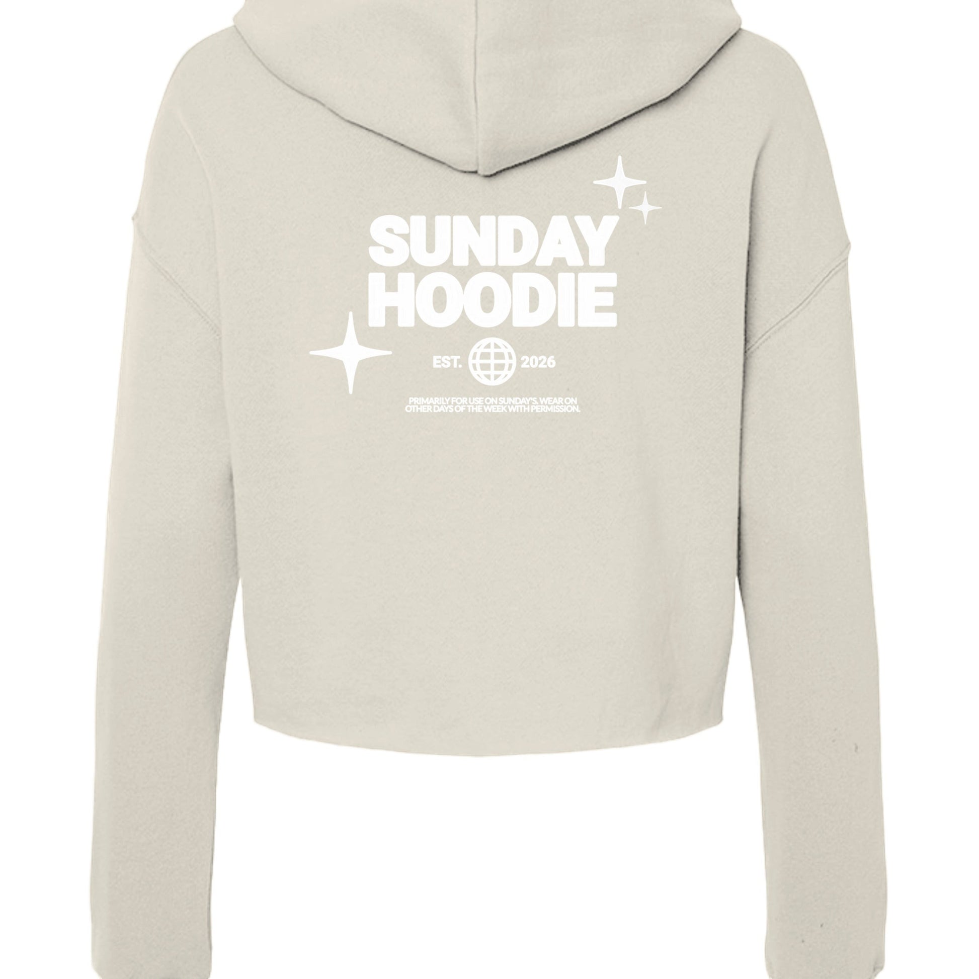 Back view of Omina Essentials beige cropped Sunday hoodie with white graphic print featuring stars and text.