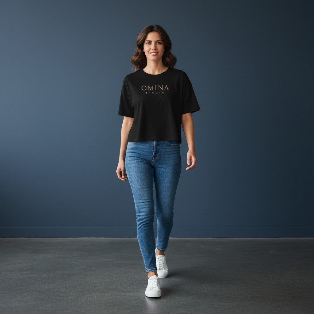 Omina Studio black 100% cotton crop top with oversized sleeves and relaxed fit, featuring a gold Omina Studio logo on the chest.