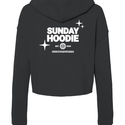 Back view of Omina Essentials black cropped Sunday hoodie with white graphic print featuring stars and text.