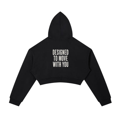 Omina black cotton blend cropped zip-up hoodie with adjustable drawstring hood and "DESIGNED TO MOVE WITH YOU" text on back.