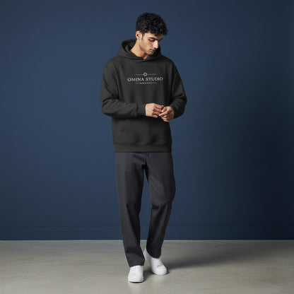 Omina Studio black heavyweight hoodie with raw edge detailing and front graphic logo. Relaxed fit, fleece interior.