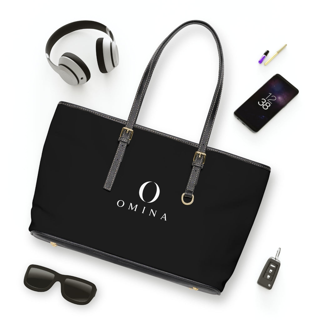 Omina black PU leather shoulder tote bag with gold hardware, adjustable straps, and centered white brand logo.