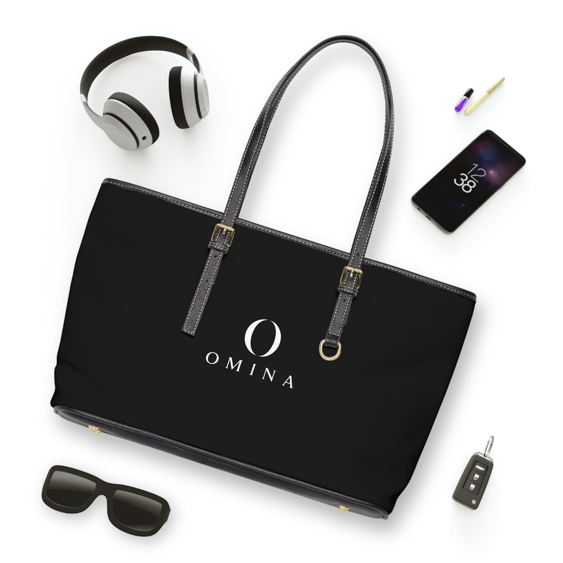 Omina black PU leather shoulder tote bag with gold hardware, adjustable straps, and centered white brand logo.