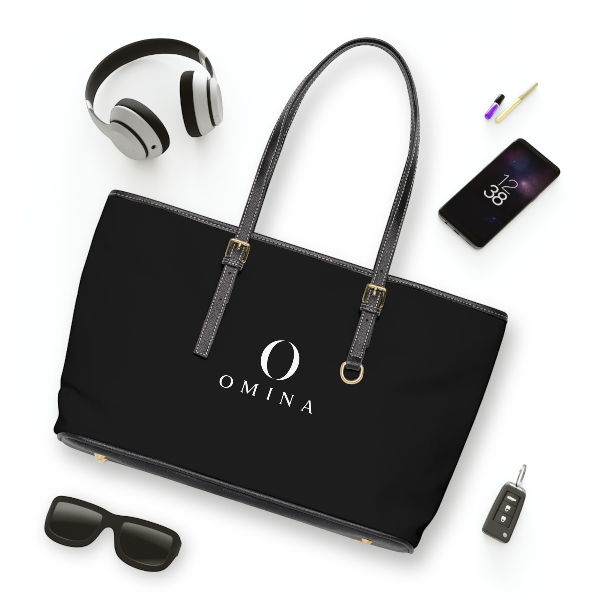 Omina black PU leather shoulder tote bag with gold hardware, adjustable straps, and centered white brand logo.