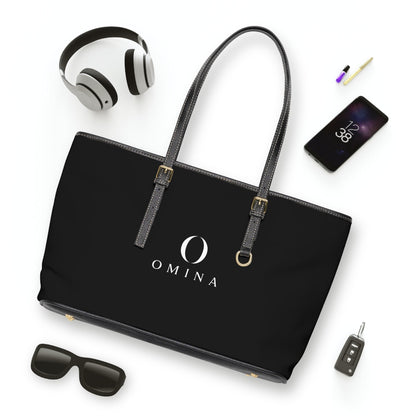 Omina black PU leather shoulder tote bag with gold hardware, adjustable straps, and centered white brand logo.