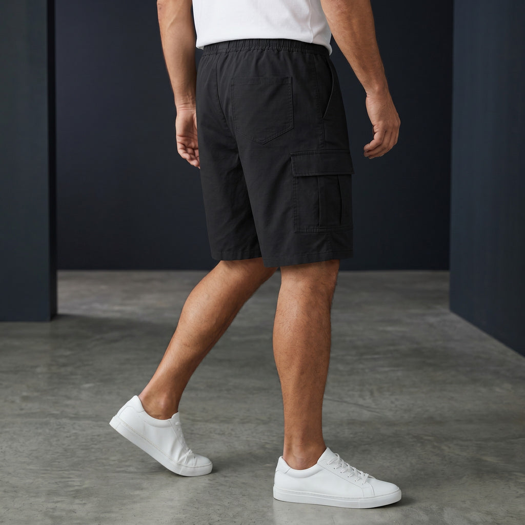 Omina black polyester unisex cargo shorts with elastic waistband and drawstring, featuring functional cargo pockets.