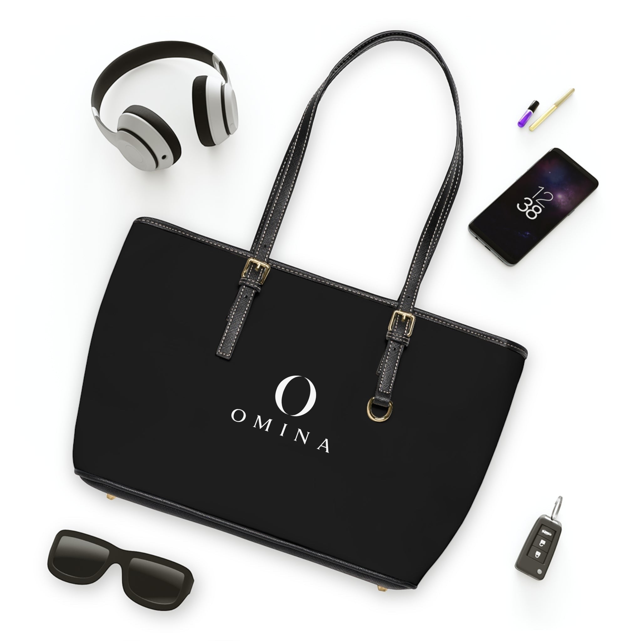 Omina black PU leather shoulder tote bag with gold hardware, adjustable straps, and centered white logo.