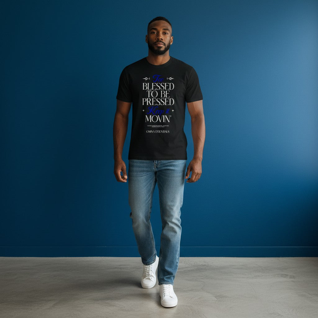 Man wearing Omina Blessed, Not Pressed black heavyweight cotton t-shirt with white and blue graphic text.