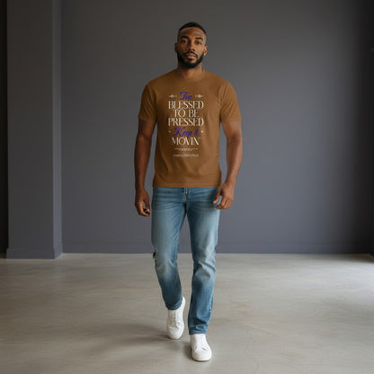 Man wearing Omina Blessed, Not Pressed brown heavyweight cotton t-shirt with graphic text, paired with blue jeans.