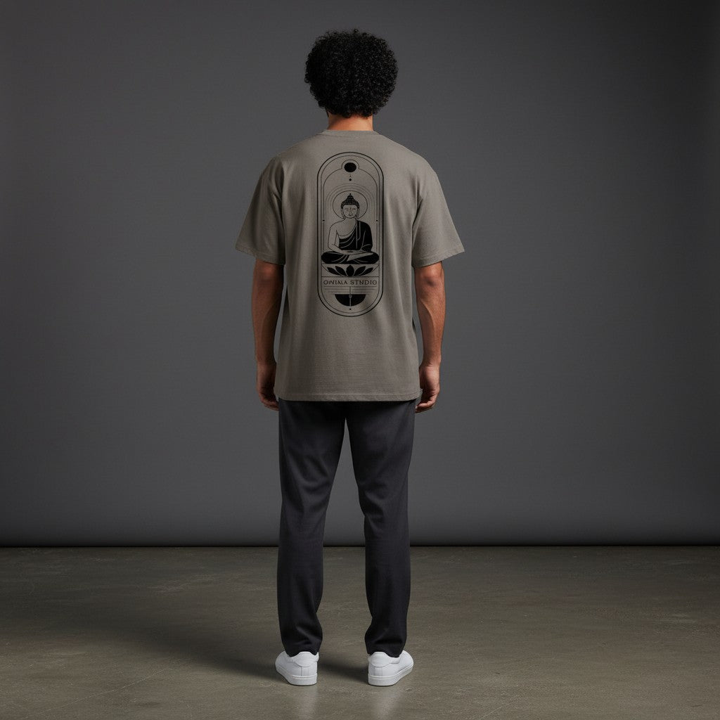 Back view of a man wearing an Omina heavyweight taupe cotton t-shirt with a black Buddha graphic print.