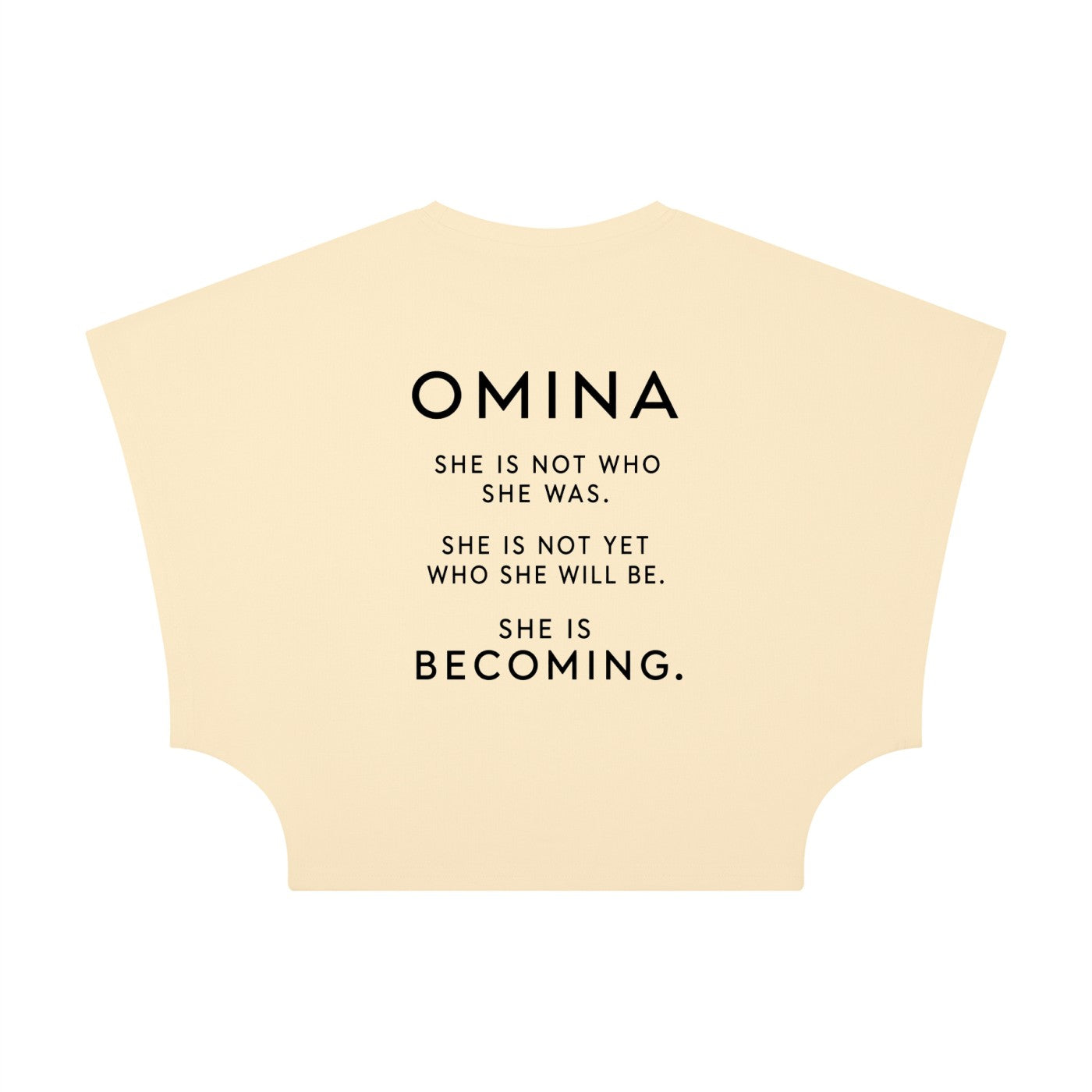 Omina women's cropped dolman t-shirt in light yellow, made of viscose and spandex, with a round neck and short raglan sleeves. Features text: "SHE IS NOT WHO SHE WAS. SHE IS NOT YET WHO SHE WILL BE. SHE IS BECOMING."