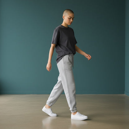 Omina women wearing grey cotton blend jogged sweatpants with an elastic drawstring waist and white sneakers