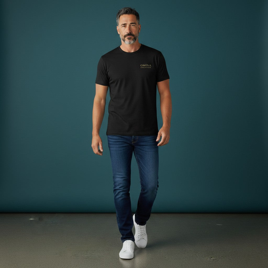 Omina Essentials black heavyweight cotton t-shirt with gold logo on left chest. Relaxed oversized fit.