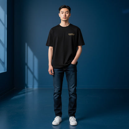 Omina Essentials black heavyweight cotton t-shirt with gold logo on chest, relaxed oversized fit, drop shoulders.