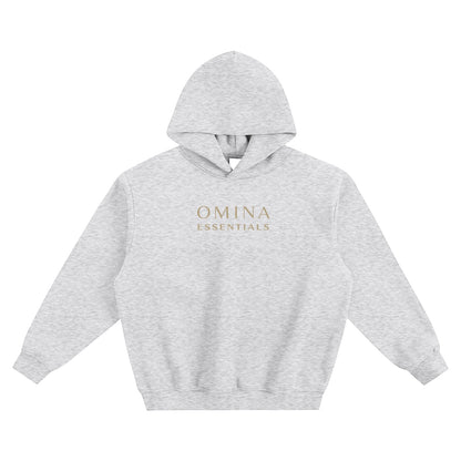 Omina Essentials light grey fleeced boxy hoodie with gold logo on chest and drop shoulders.