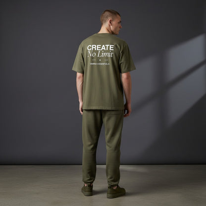 OMINA Essentials No Limit heavyweight cotton t-shirt in olive green with drop shoulders and crew neck. Model wears matching pants.